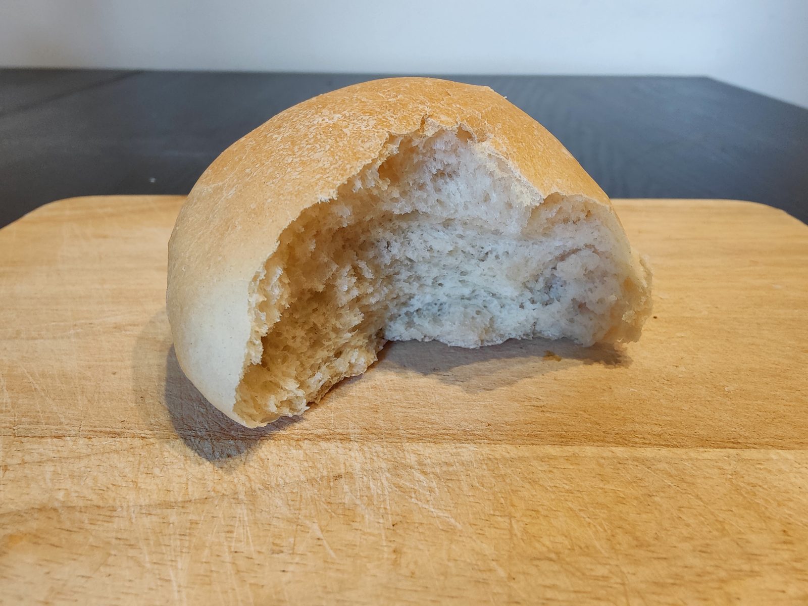 A bun torn open, showing the soft crumb